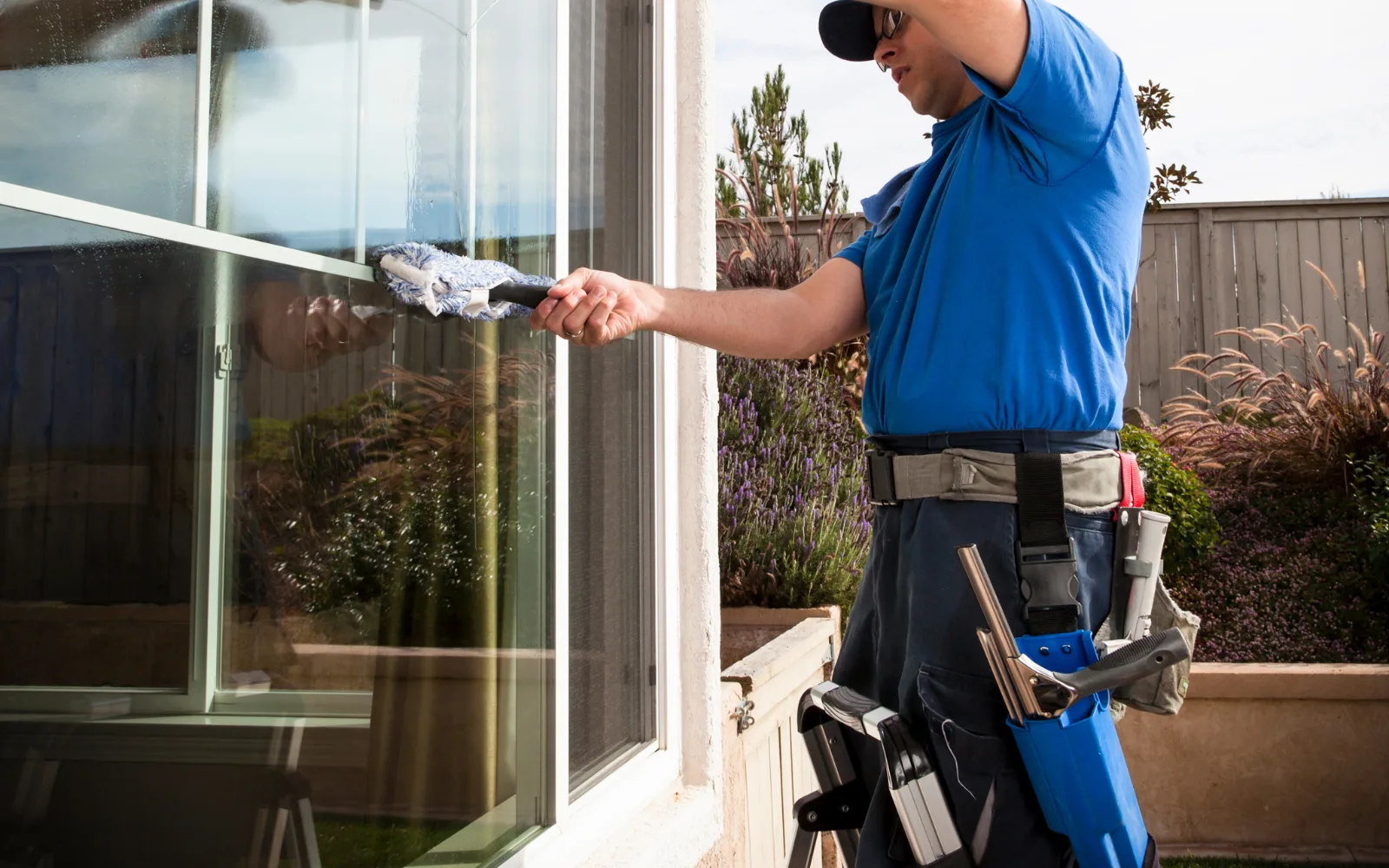 Bay Windows technician cleaning windows on a residential property